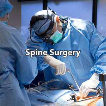 Doctor performing spinal surgery in operating room