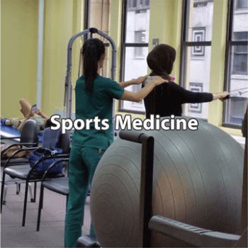 Sports medicine doctor assisting patient with exercises