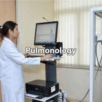 Pulmonary Doctor updating patient records in exam room