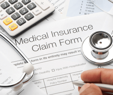 Medical Insuranc Claim Form with calculator and stethoscope