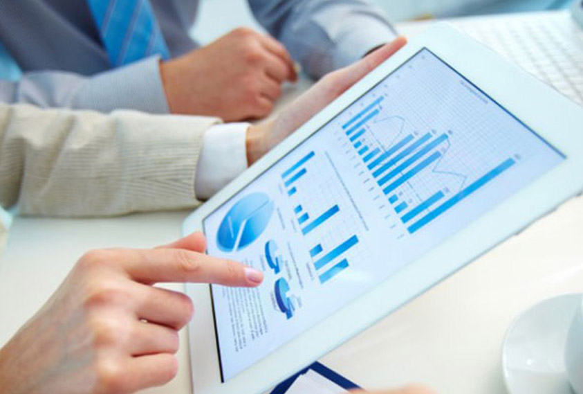 Close up of two businessmen looking at report on tablet