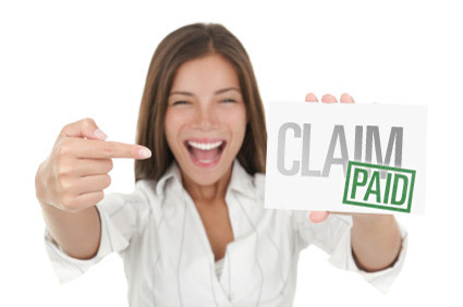 Woman smiling and pointing to her paid claim